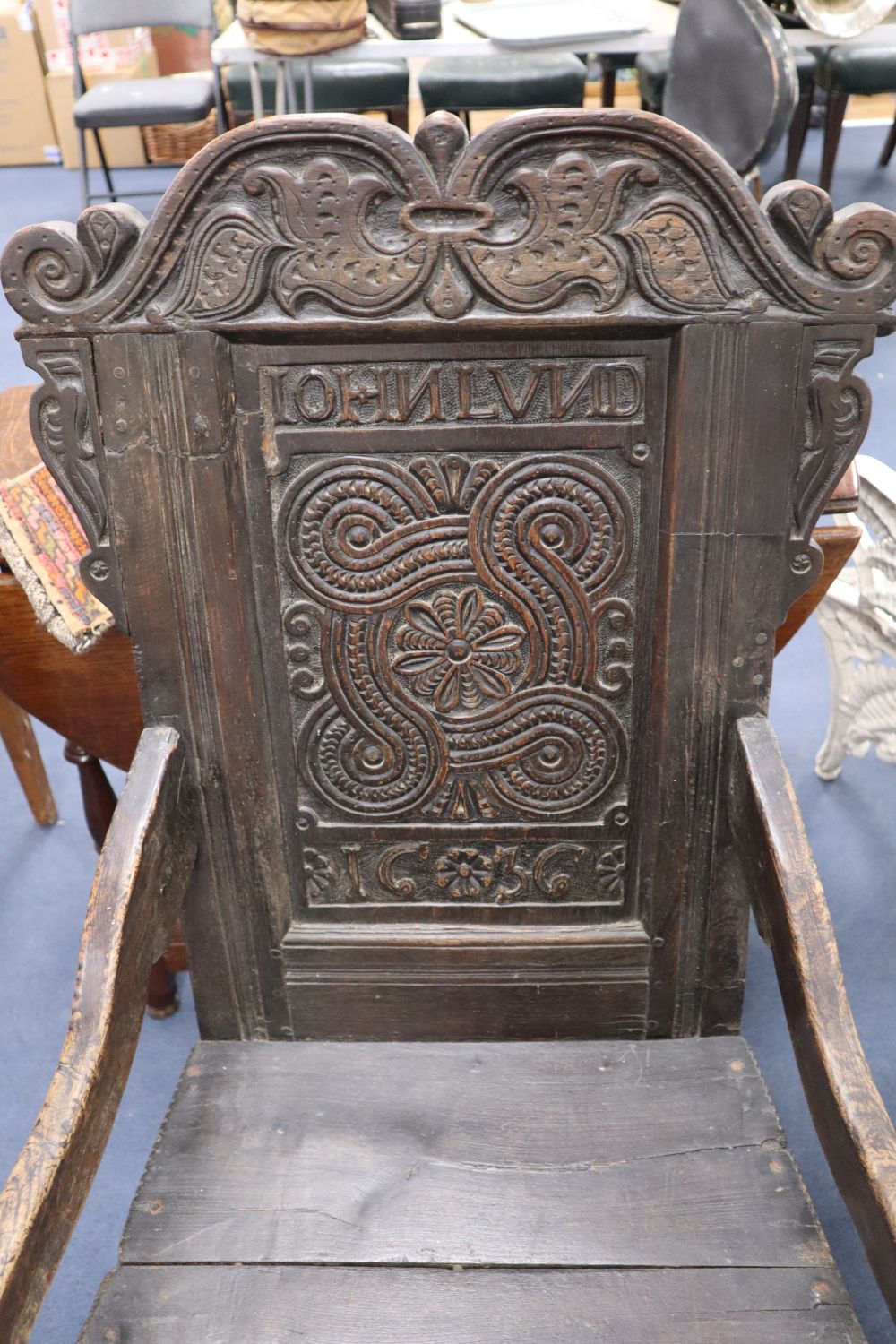 A Charles I oak panel back Wainscot chair, the central panel carved JOHN LUND 1636, some alterations, width 57cm height 111cm